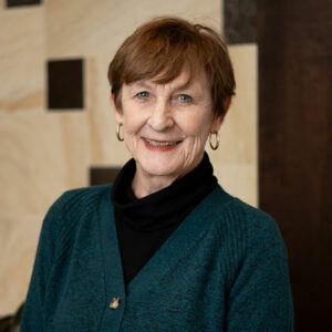 Headshot of Pat Hastings in a teal cardigan and black turtleneck