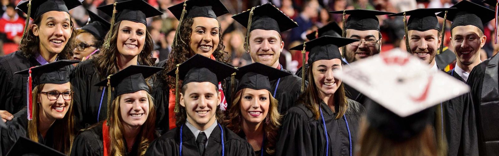 A group of graduates pose for a photo during UW-Madison's winter commencement ceremony at the Kohl Center at the University of Wisconsin-Madison on Dec. 20, 2015. The indoor graduation was attended by approximately 1,200 bachelor's and master's degree candidates, plus their guests. (Photo by Jeff Miller/UW-Madison)