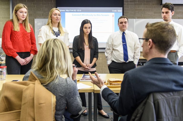 Students in a Digital Media Strategies class taught by Debra Pierce, faculty associate in the School of Journalism and Mass Communication at the University of Wisconsin-Madison, field questions following their presentation on solutions to real-world business communication problems to a panel that includes representatives from American Family Insurance in the Digital Media Studios in College Library.
