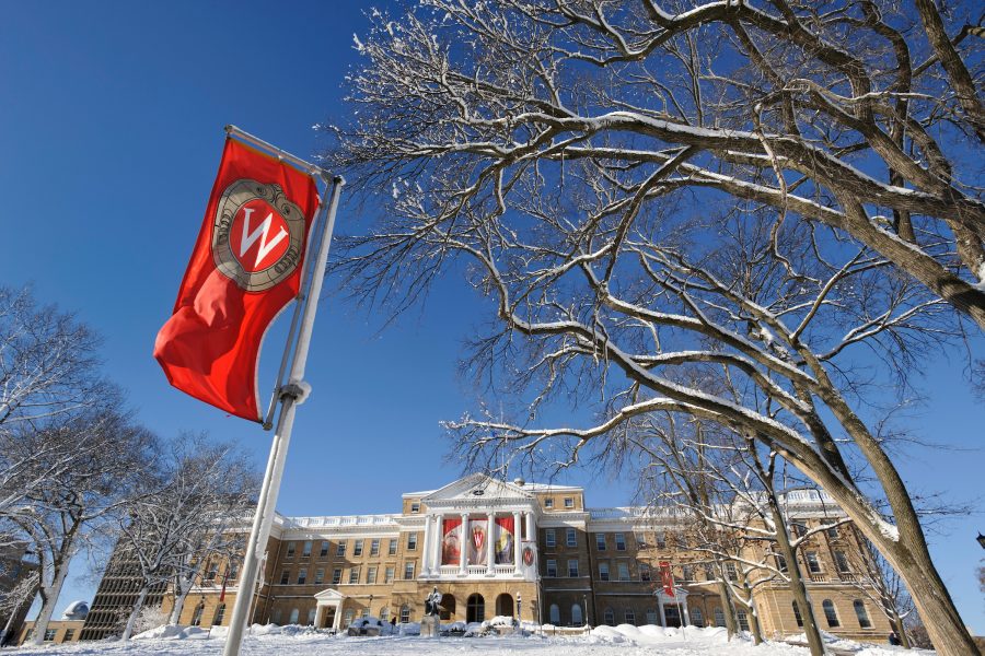 A fresh snowfall covers the Abraham Lincoln statue and Bascom Hall at the University of Wisconsin-Madison on the morning of Dec. 21, 2012. In the foreground hang institutional W crest banners.