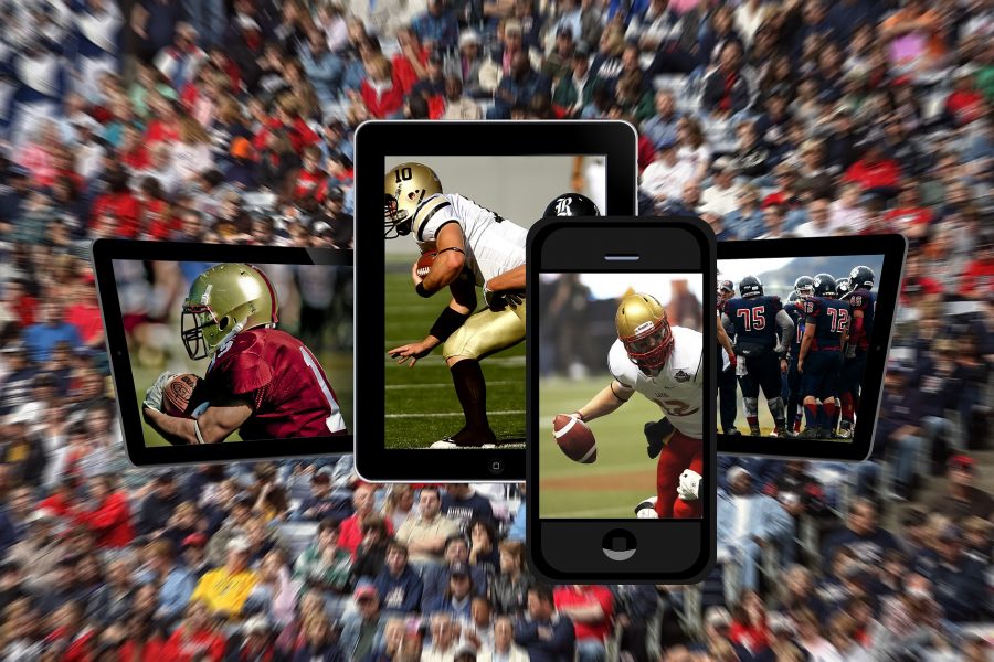 Smartphones and tablets displaying images of football players superimposed on a blurred background image of a crowd at a sporting event