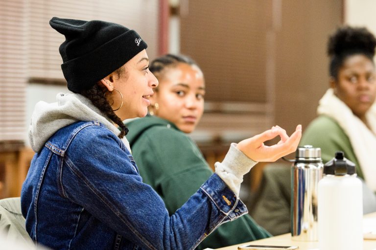 Students from The Black Voice discussing a multimedia project