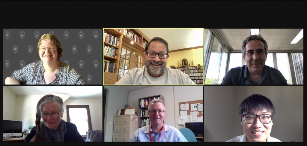 A Zoom call with six people smiling
