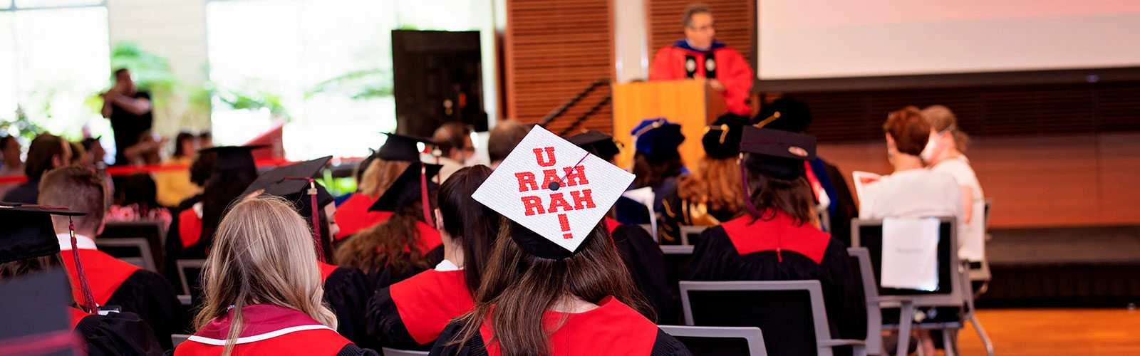 Female student with decorated graduation cap at the SJMC graduation celebration
