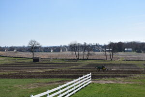 Tractor driving through a large farm field
