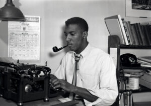 Bob Teague was an accomplished journalist. He is pictured here typing on a typewriter.