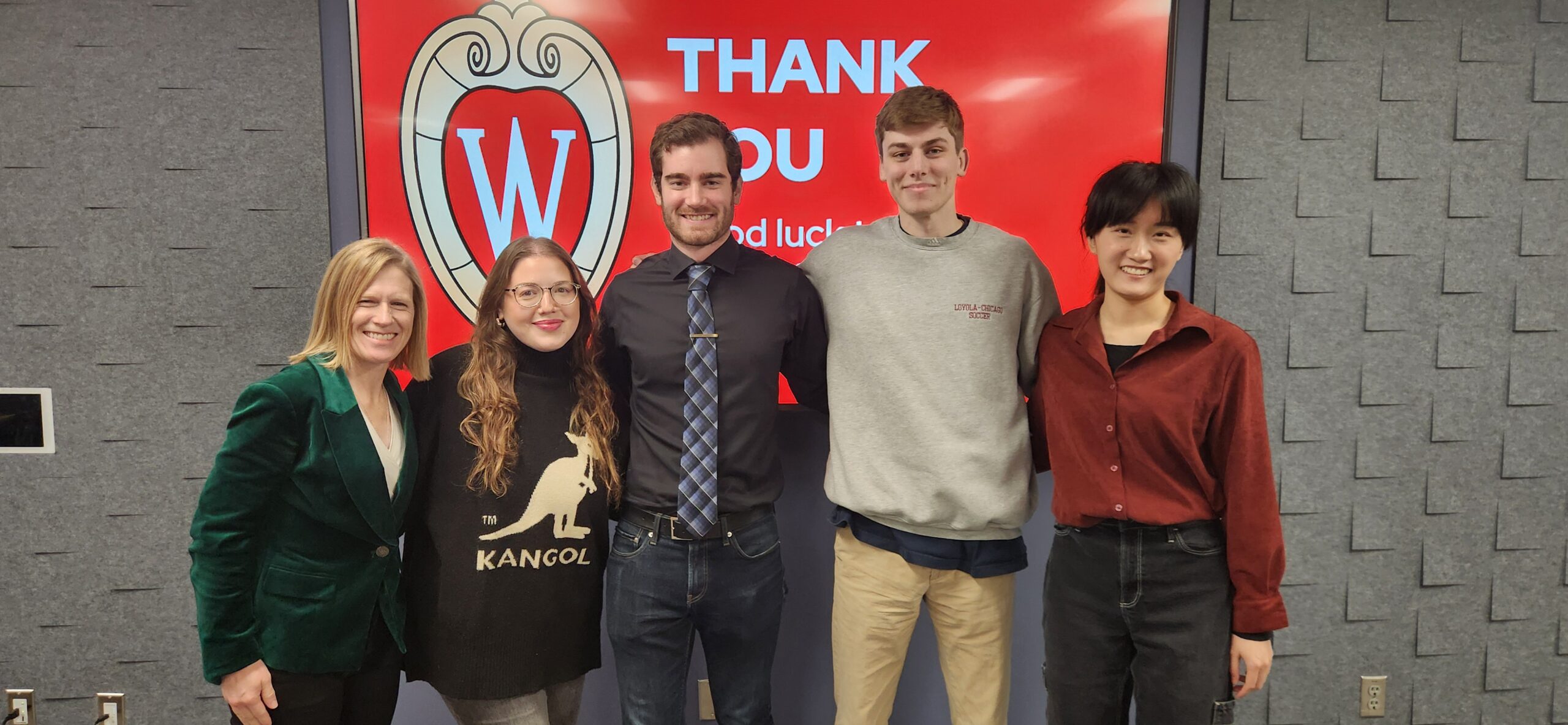 Four Professional Master's program graduates pose with Stacy Forster after their portfolio showcase