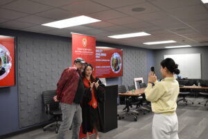 Professor Doug McLeod poses with a graduate at the 2023 Winter Graduation Celebration.