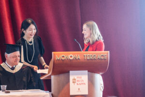 Kate Lewicki presents professor Young Mie Kim with her Teaching Excellence Award.
