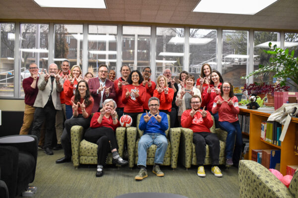 SJMC faculty and staff pose together to celebrate Day of the Badger.