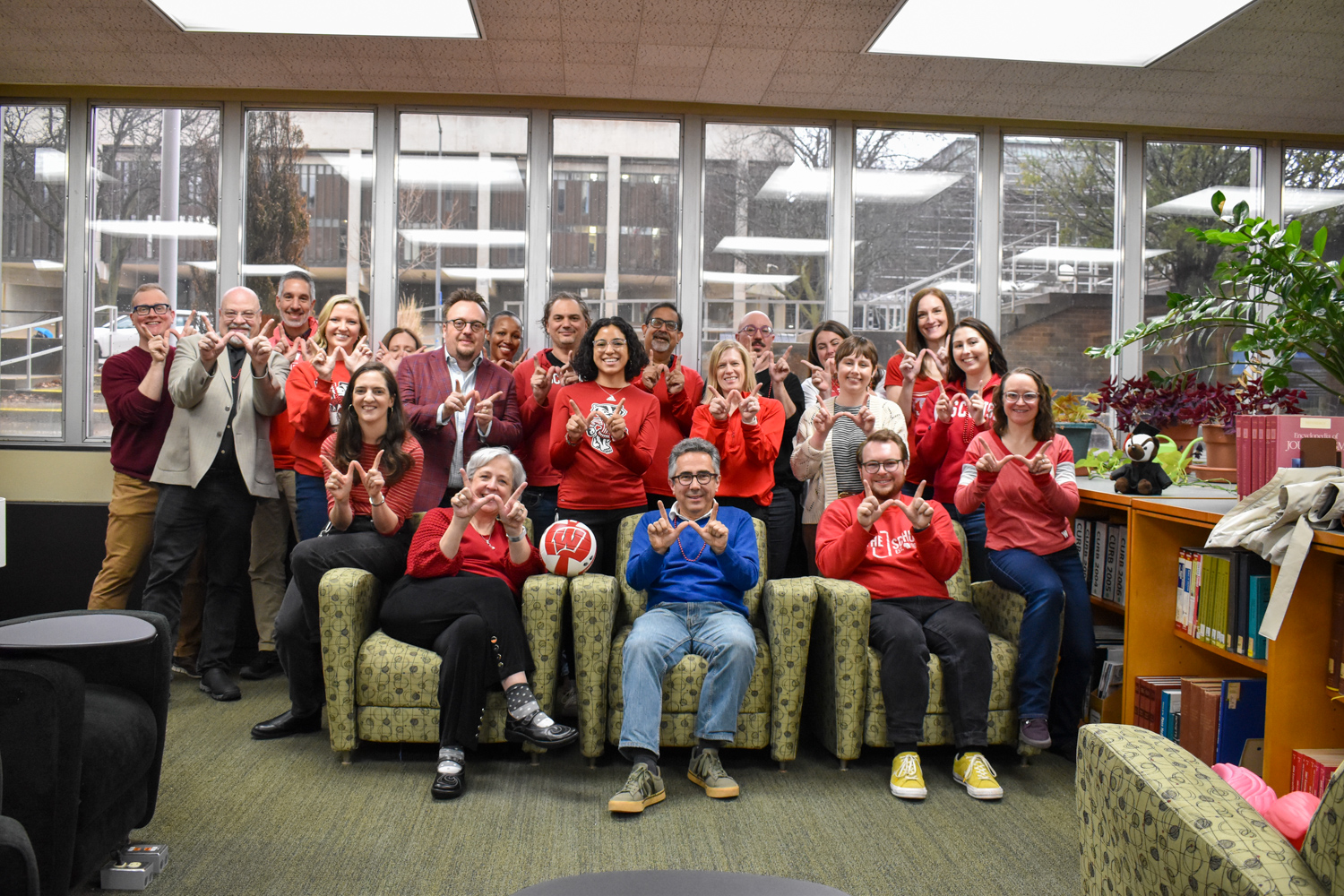 SJMC faculty and staff pose together to celebrate Day of the Badger.