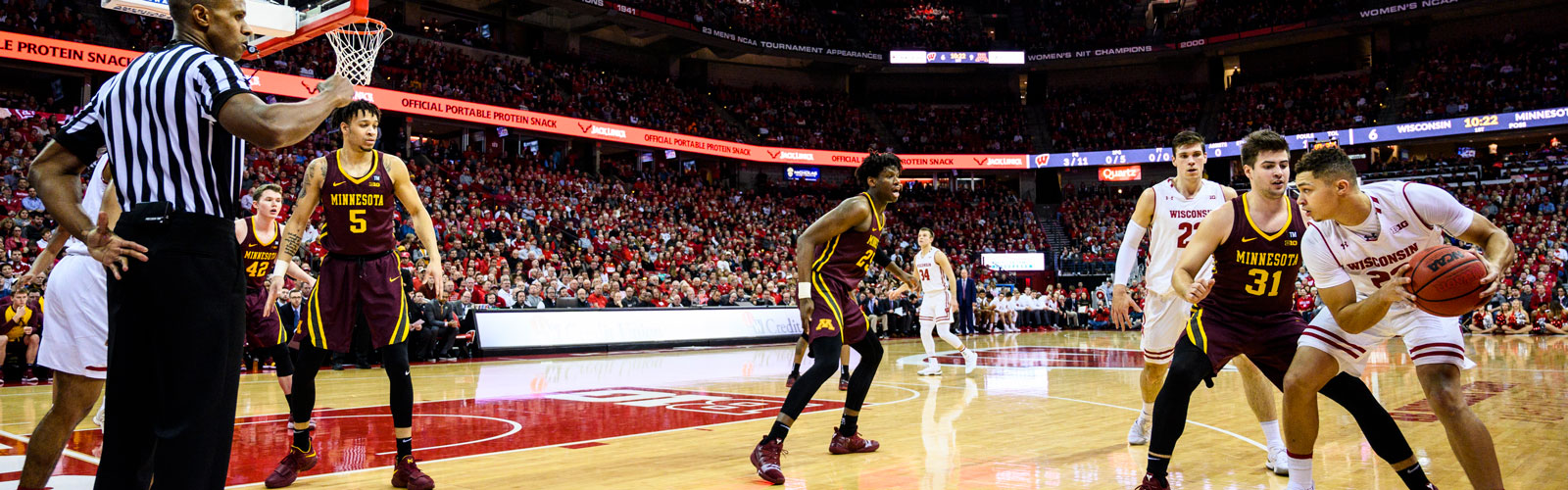 A Badger men's basketball player looks to pass the basketball during a game