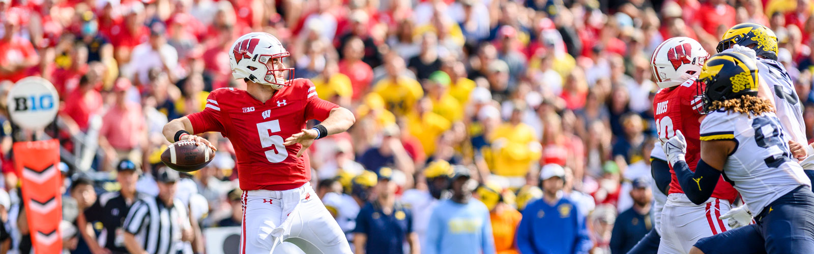 A Badger football quarterback prepares to throw the football.