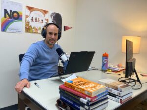 Elohim Monard recording his podcast in his office