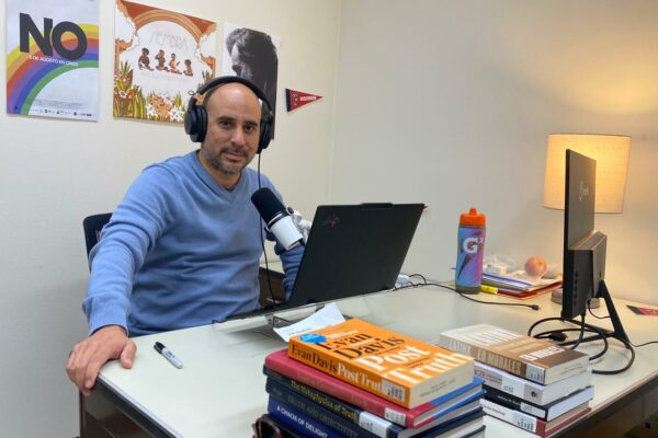Elohim Monard recording his podcast in his office