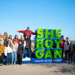 Students in Professor Doug McLeod's J445 Creative Campaign Messages class pose together in front of a Sheboygan sign while on a field trip to Sheboygan.
