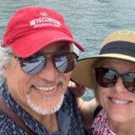 Michael Aguilar and his wife pose for a selfie across the harbor from the Sydney Opera House.