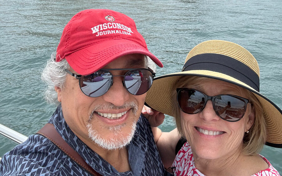 Michael Aguilar and his wife pose for a selfie across the harbor from the Sydney Opera House.