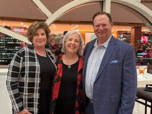 Brenda Pogorzelski, SJMC Director Katy Culver and Steve Pogorzelski pose together at an event.