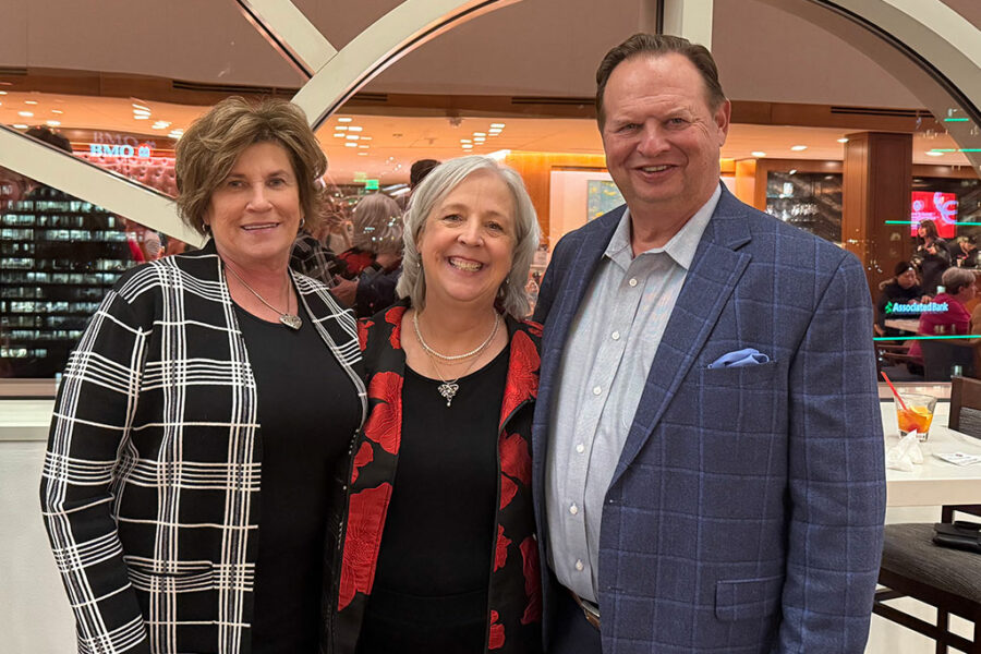 Brenda Pogorzelski, SJMC Director Katy Culver and Steve Pogorzelski pose together at an event.