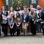 A group of students pose together in a large group