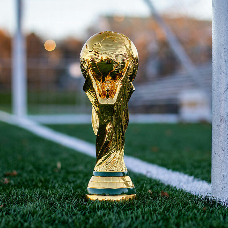 World Cup trophy on a soccer field near a goal