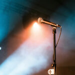 A microphone on a stand with lights shining up at it